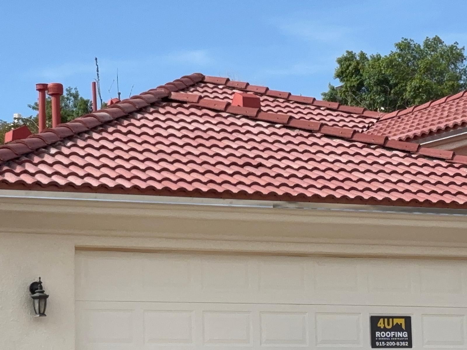 Completed red clay tile roof replacement in El Paso with 4U Roofing yard sign