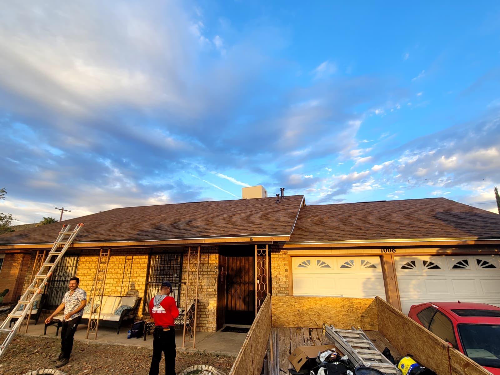 4U Roofing crew finishing a shingle roof replacement in El Paso at dusk