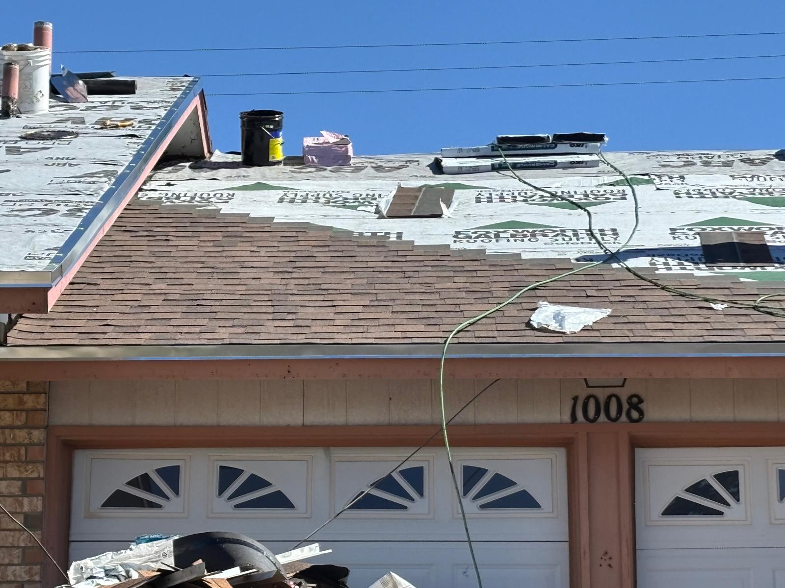 Architectural shingle roof mid-installation over new underlayment